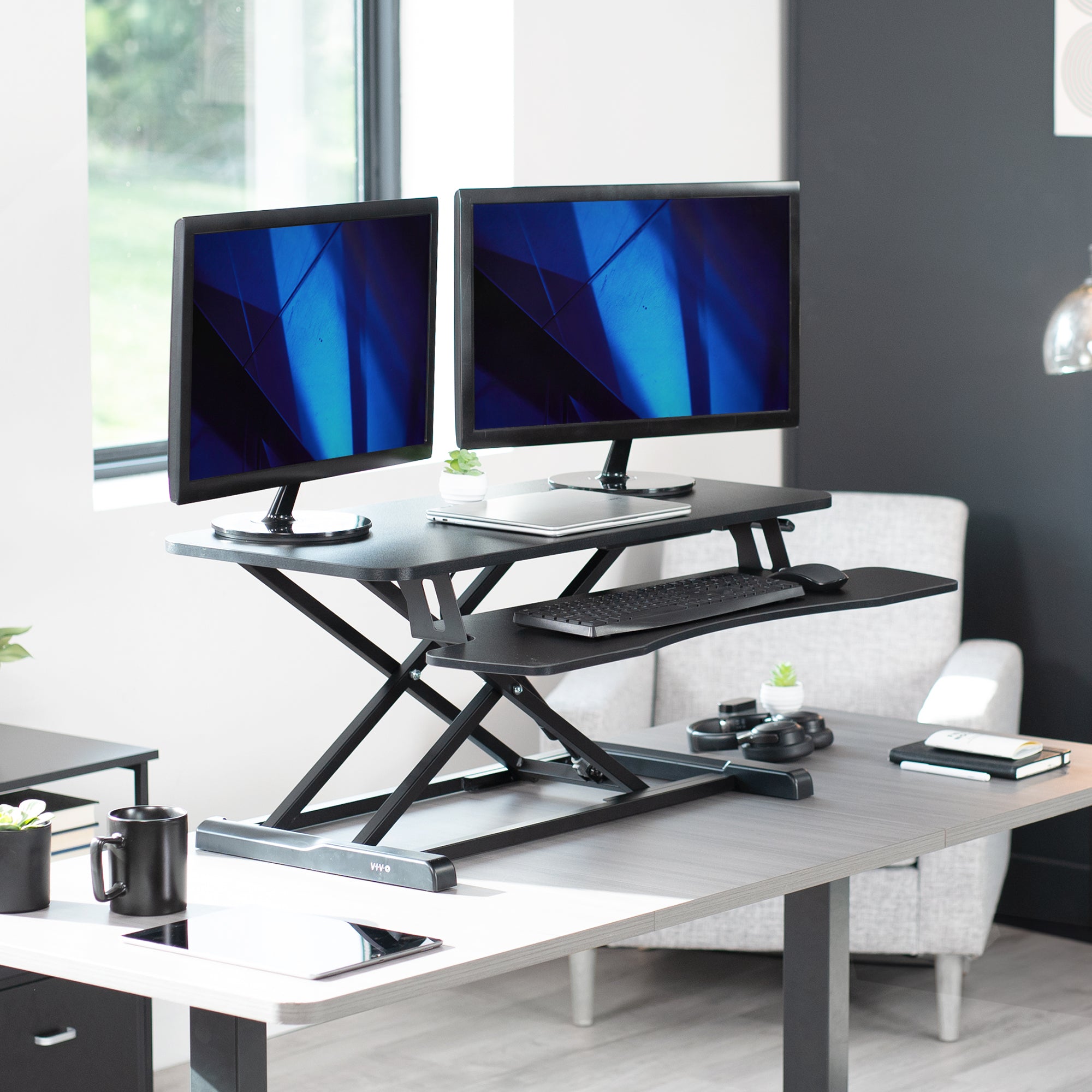 Sturdy height adjustable 2-tiered desk riser for ergonomic office workstation.