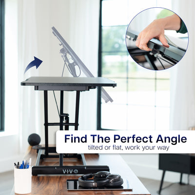 Adjustable standing desk with a hand adjusting the tilt angle, in a home office environment.