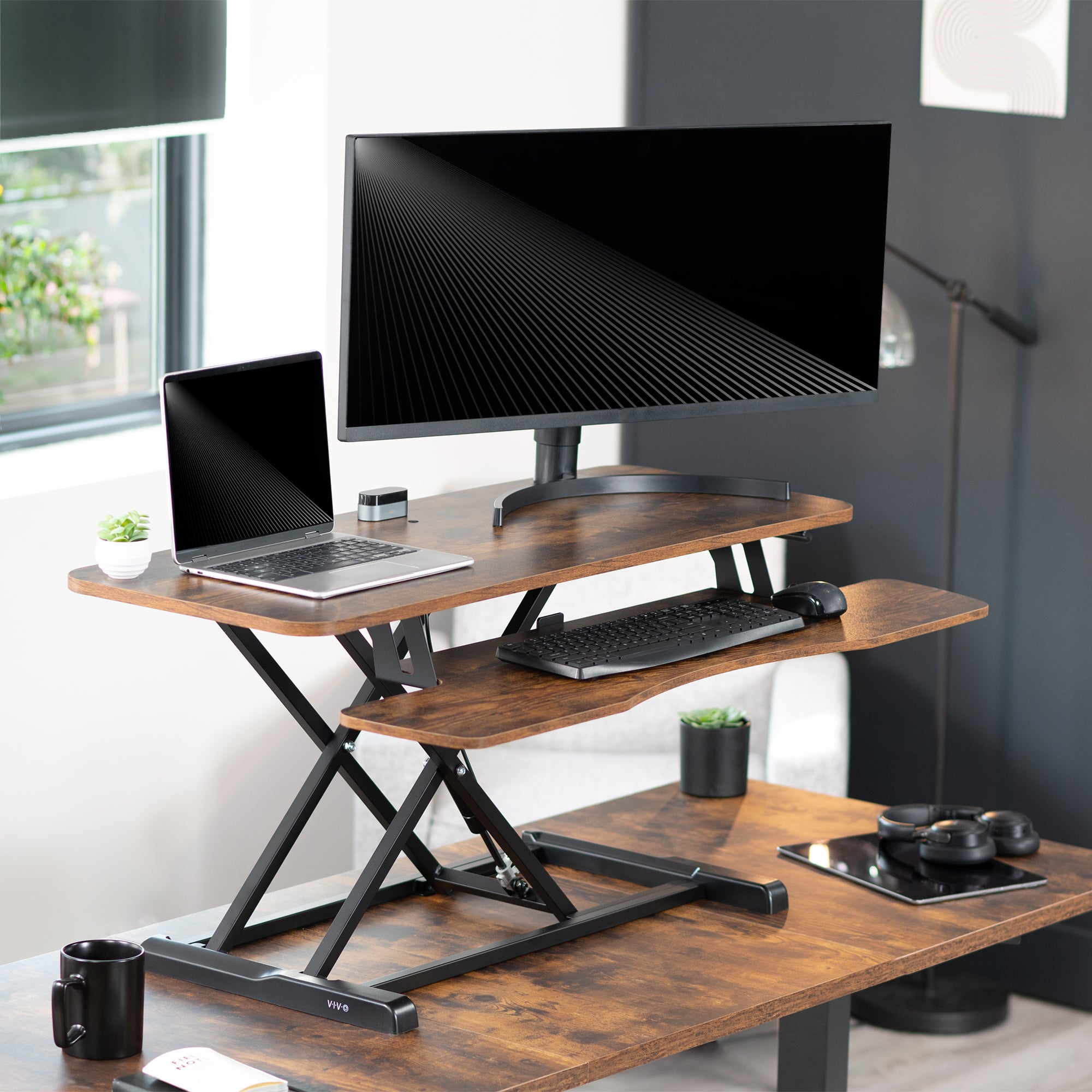 Sturdy height adjustable 2-tiered rustic desk riser for ergonomic office workstation.