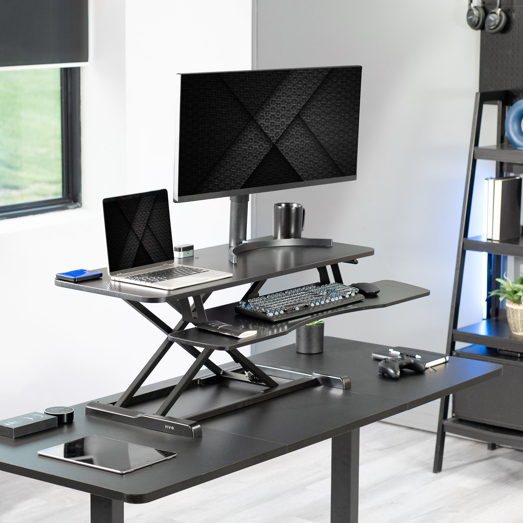 Sturdy height adjustable 2-tiered desk riser for ergonomic office workstation.