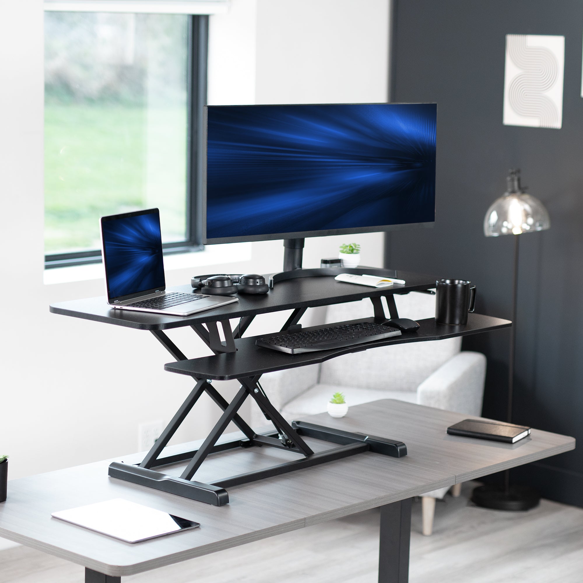 Sturdy height adjustable 2-tiered desk riser for ergonomic office workstation.