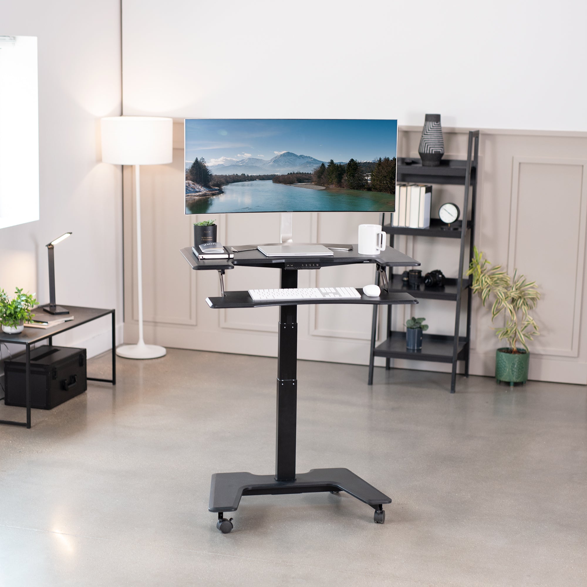 Electric mobile compact desk provides a height adjustable workstation for home or the office, featuring a 2 tier design for your screen and keyboard tray.