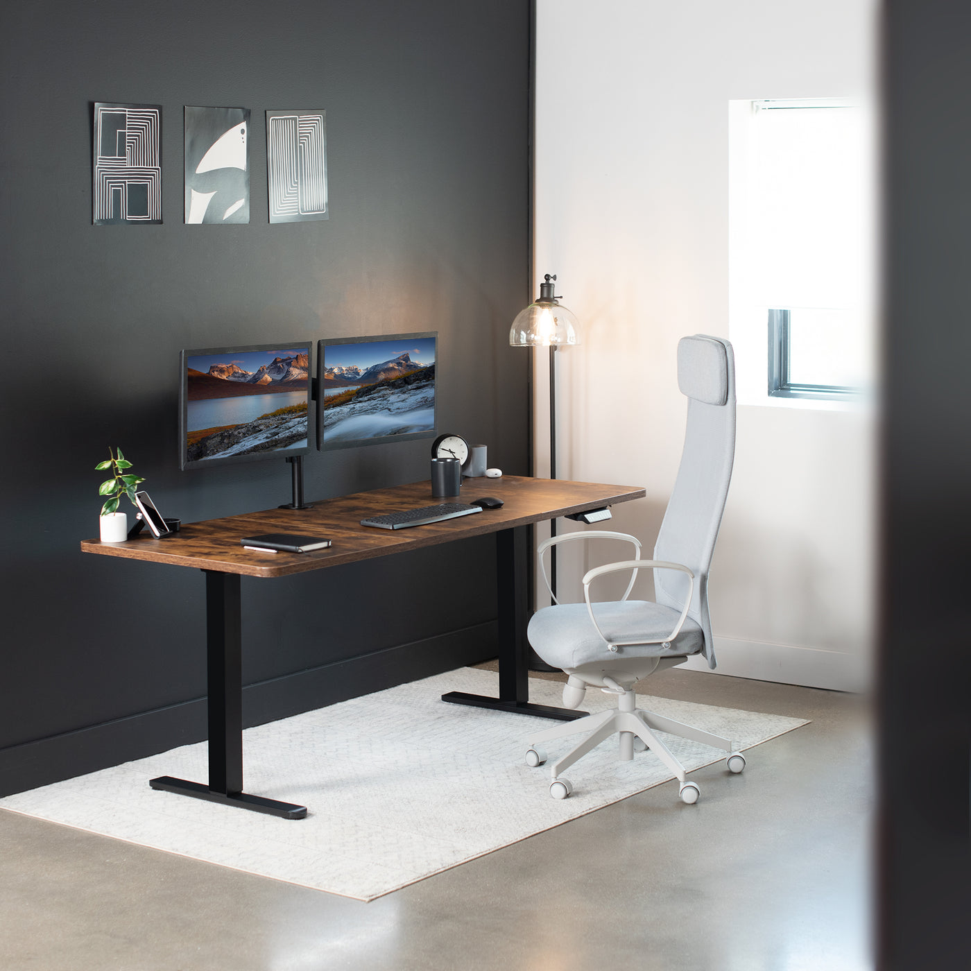 Modern office set up with a dark walnut table top on a strong dual motor desk frame.