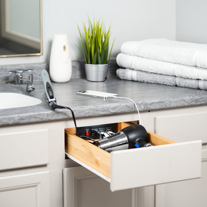 In-drawer changing station with AC outlet and USB ports.