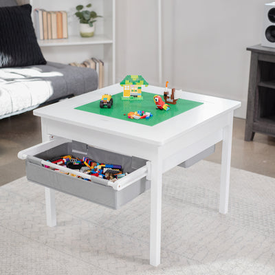 Kids' play table for Lego building bricks with reversible building base top and two pull-out drawers.