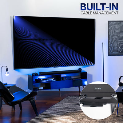 Living room with a large TV on a corner wall mount with a built-in cable management system.