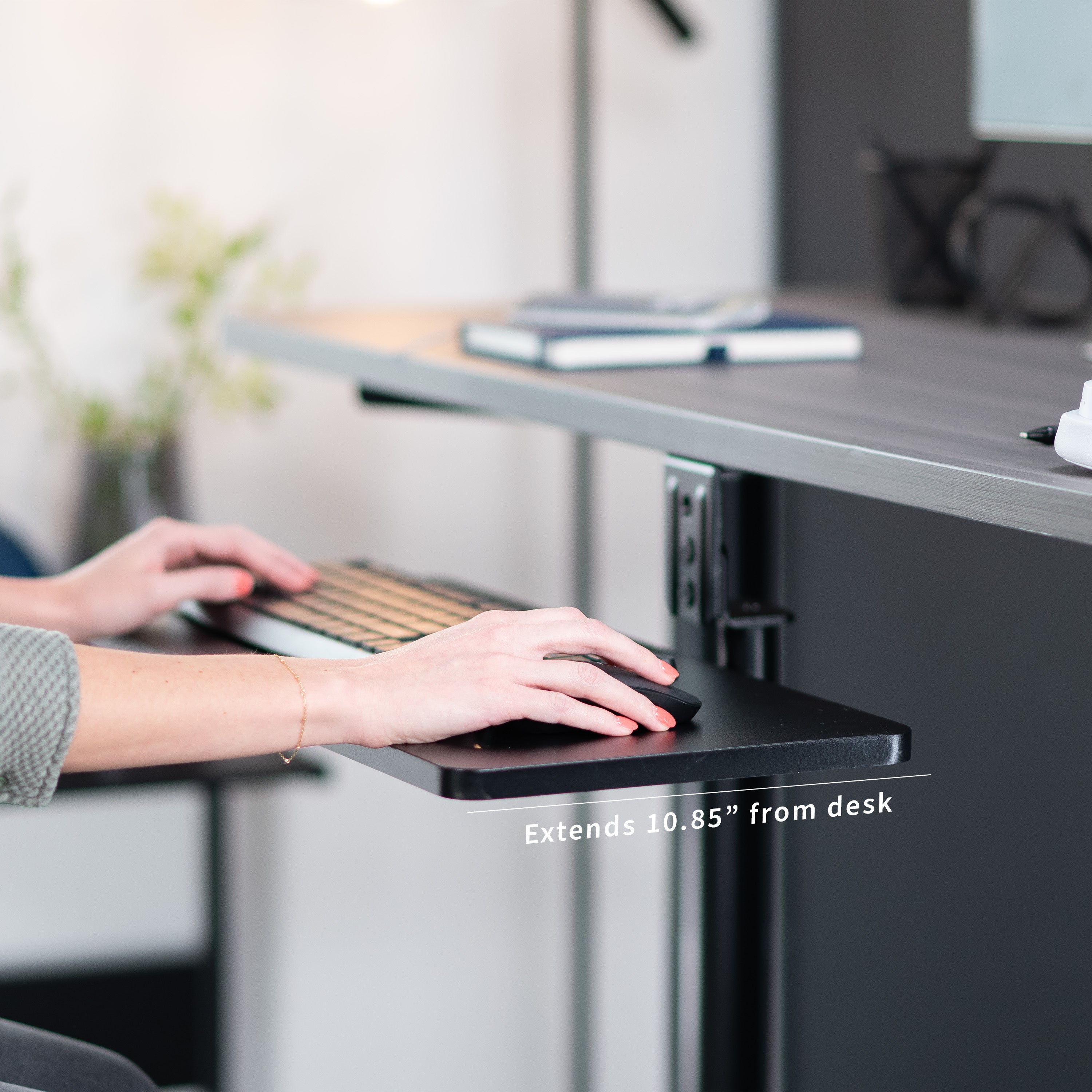 Low-profile under desk keyboard tray with 360-degree rotation.