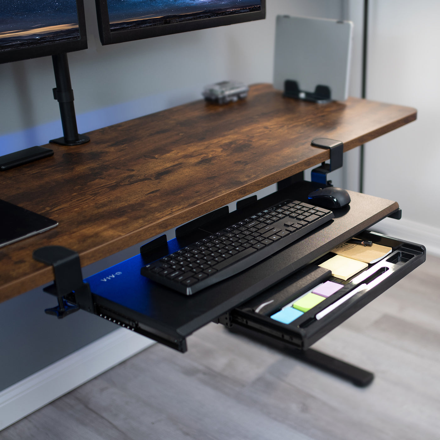 Clamp-on keyboard tray with pencil drawer for convenient space-saving desk workstation.