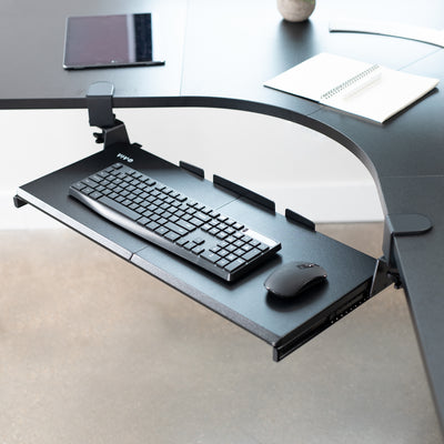 Under desk corner keyboard tray platform with adjustable swivel clamps for an ergonomic workspace.