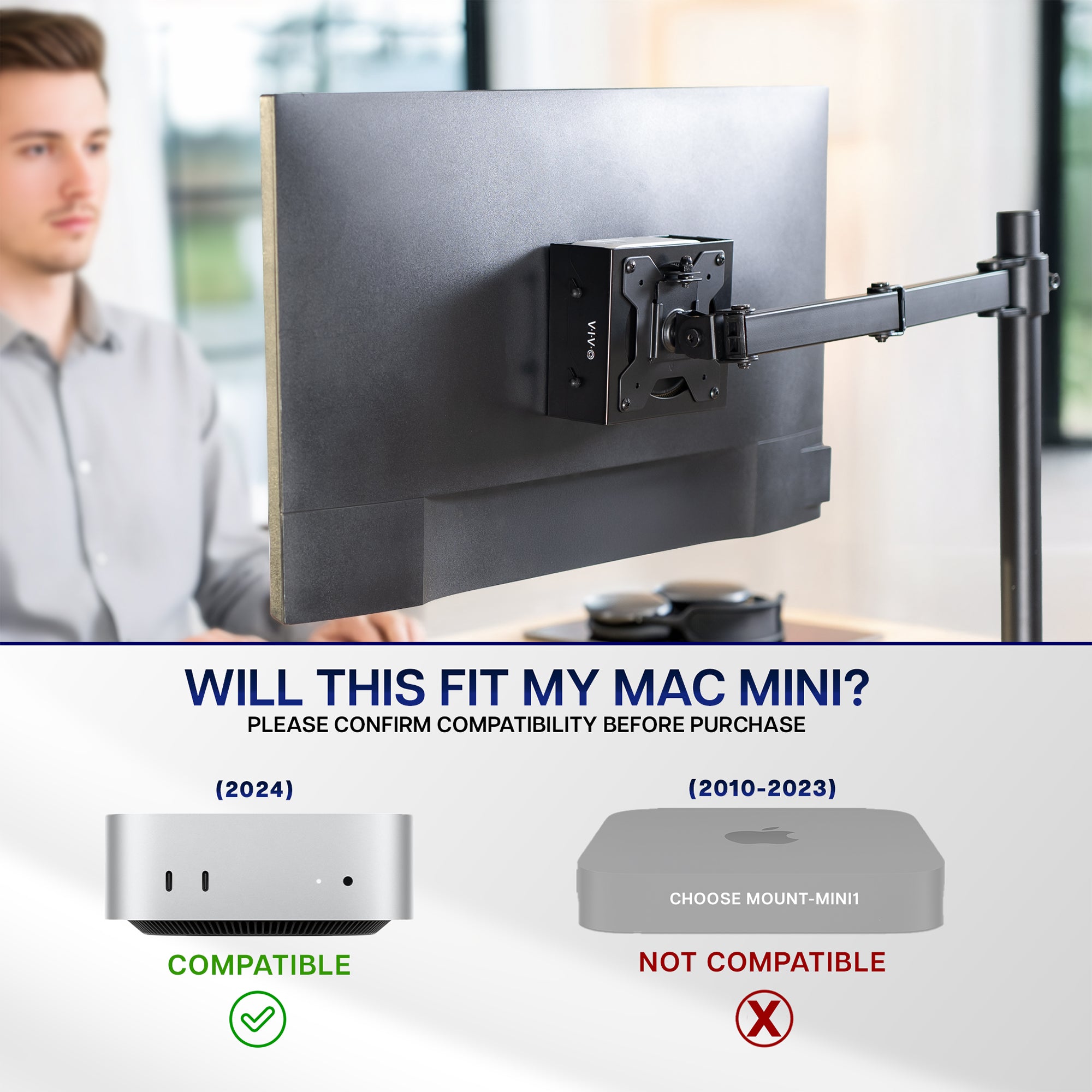 Person using a computer with a monitor on a adjustable stand with mount for Mac Mini in an office setting