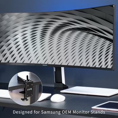 Space-saving desk clamp to mount Samsung monitor while maintaining height adjustment and articulation capabilities.