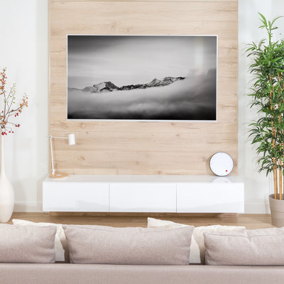 A black VESA wall mount in a living room setting. 