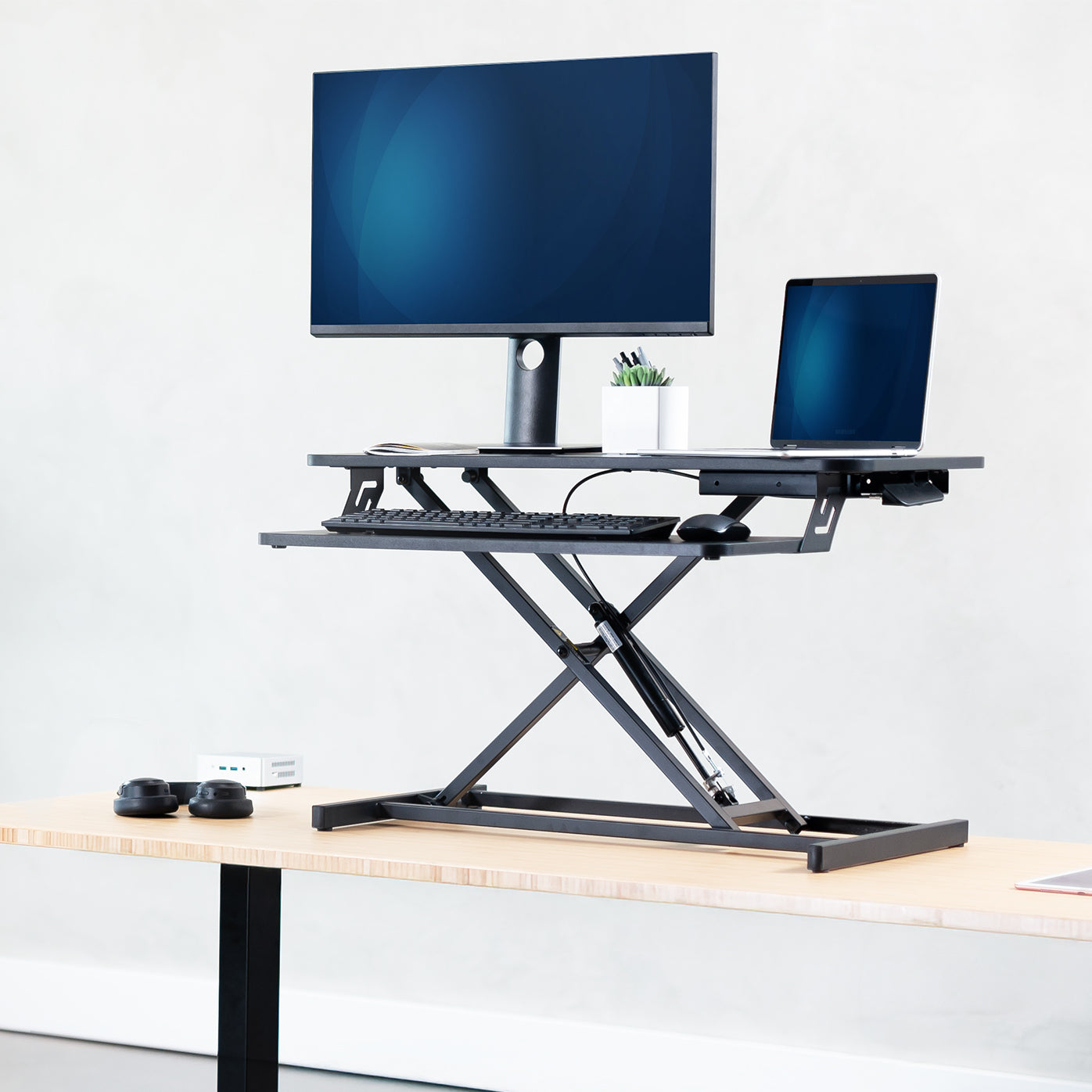 Compact height adjustable desk converter monitor riser with 2 tiers.