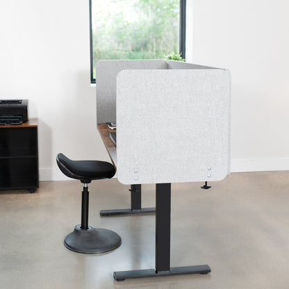 Clamp-on desk privacy panel for office workspace.