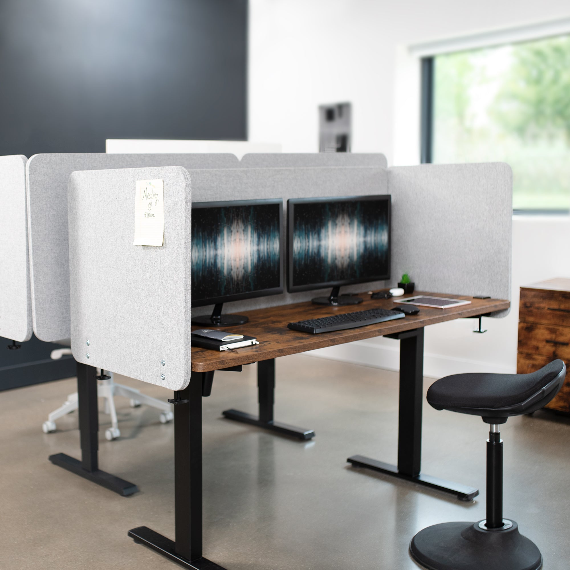 Clamp-on desk privacy panel for office workspace.