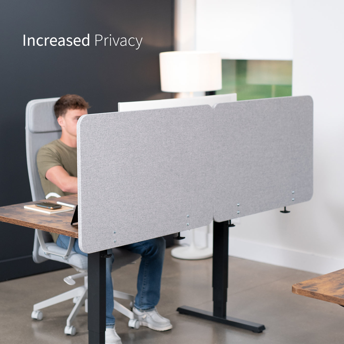 Clamp-on desk privacy panel for office workspace with increased privacy.