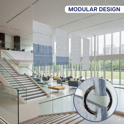 Modern office interior with modular design elements, including a staircase and glass walls and hanging panels above.