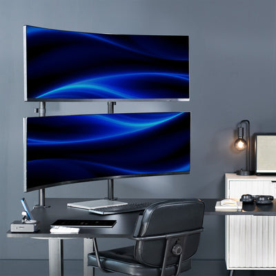 Two computer monitors mounted on dual pole designed desk mount on a desk with a chair against a gray wall in modern office space.