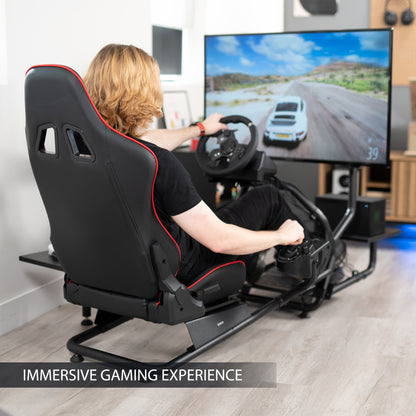 Racing simulator cockpit gaming chair with TV mount, PC shelf, and side shelf.