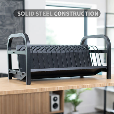 Black charging rack on a wooden surface with text overlay.