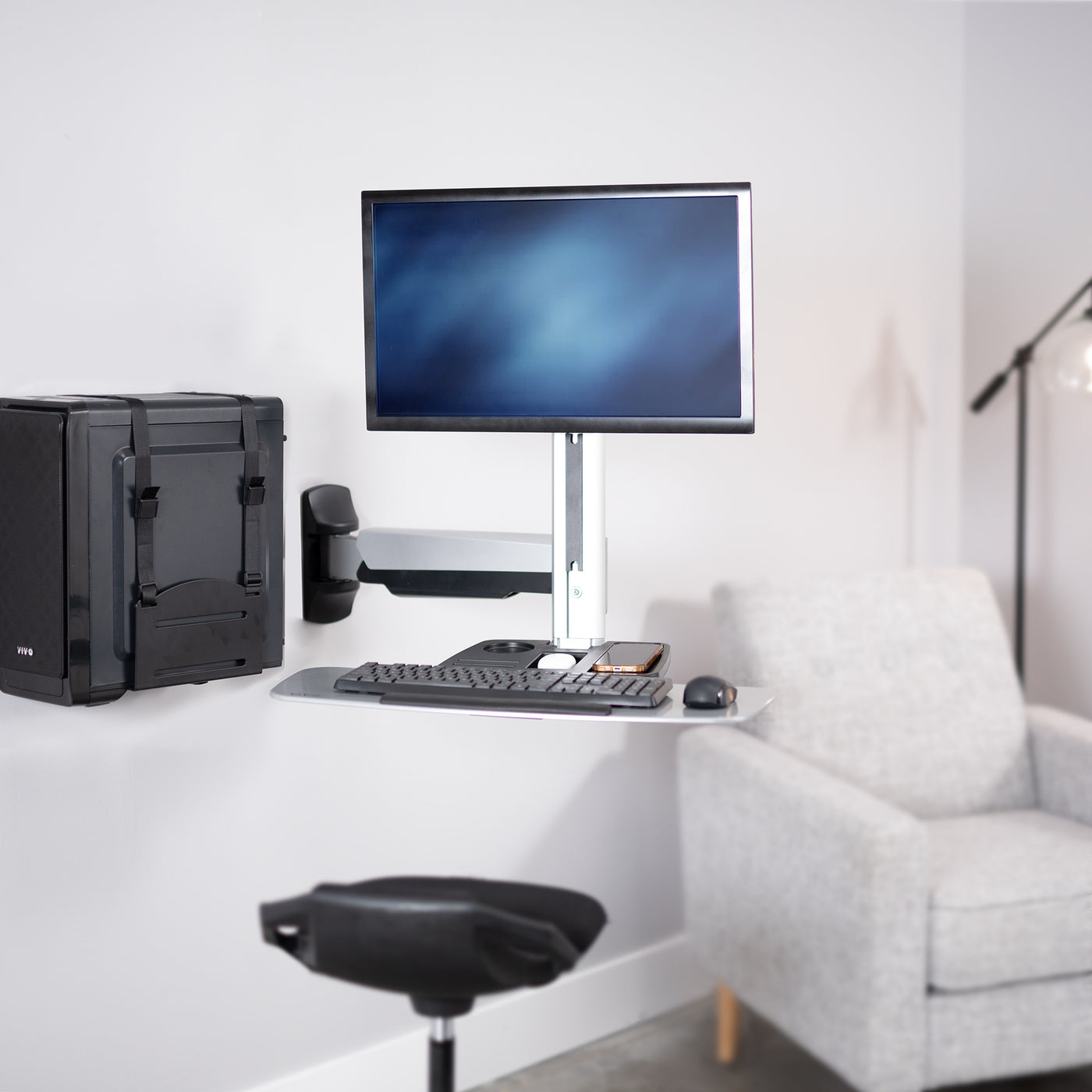 Sturdy silver ergonomic single monitor sit to stand wall mount workstation with keyboard tray.