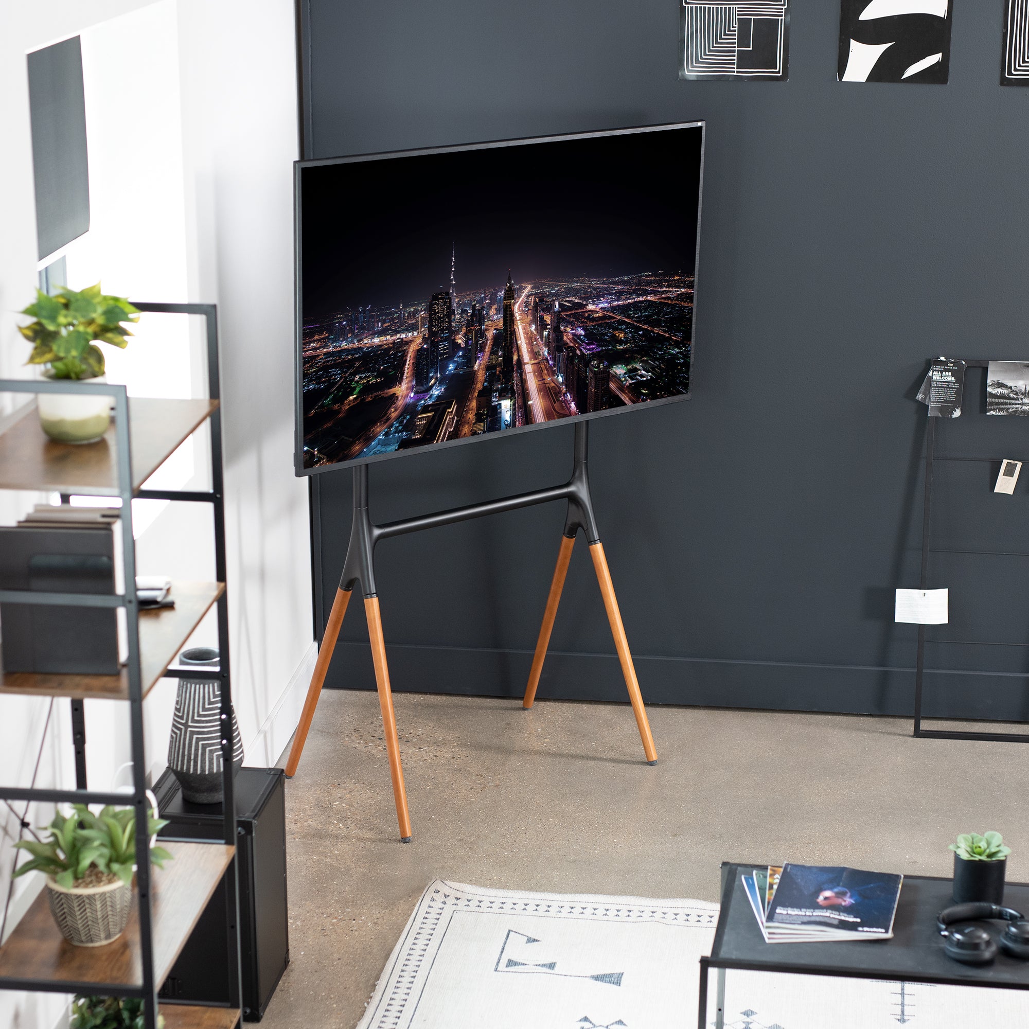 Sturdy easel studio TV stand with walnut legs.