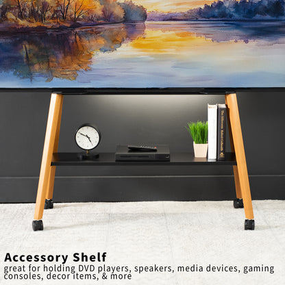 Wooden TV stand with electronic devices against a scenic wall.
