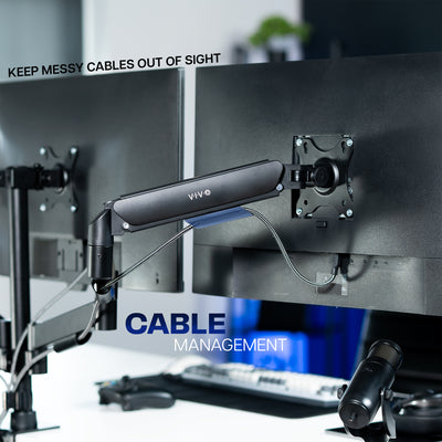 Computer monitor with cable management system on a desk