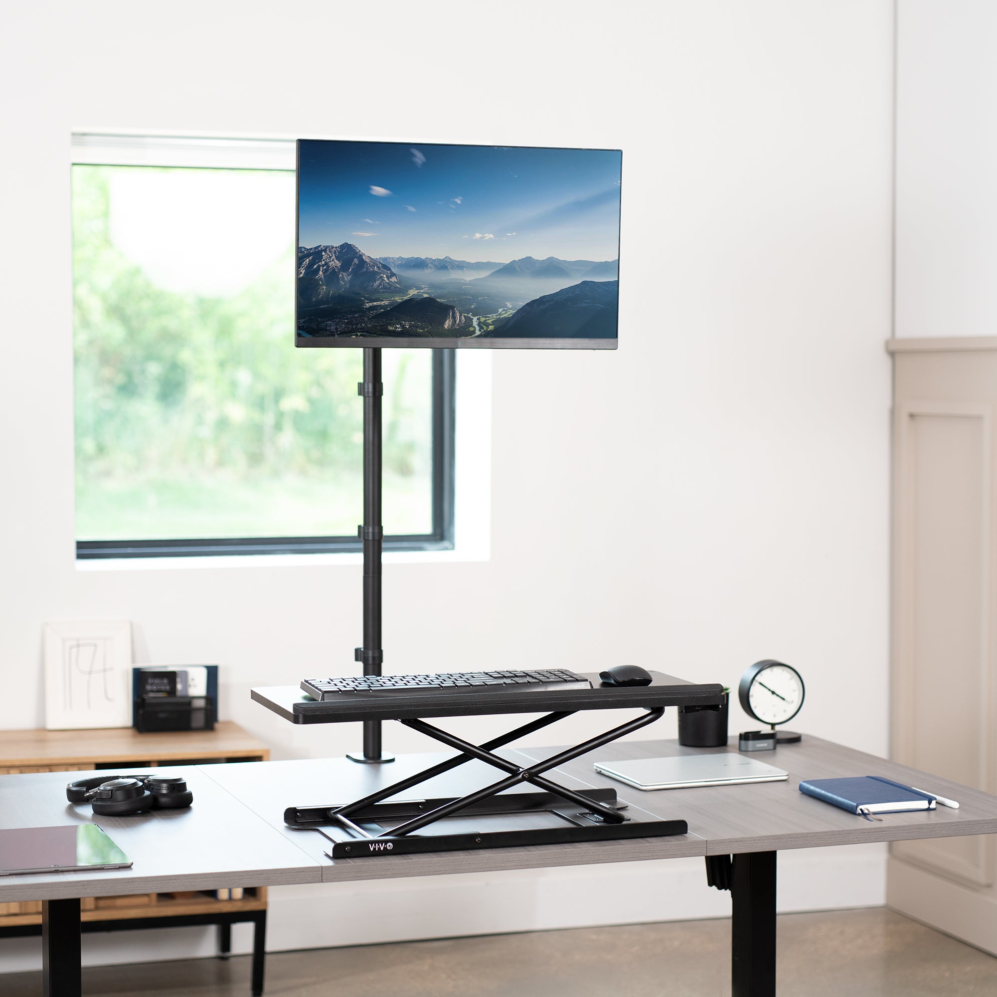 Extra tall desk mount for single monitor provides sit or stand application for the user.