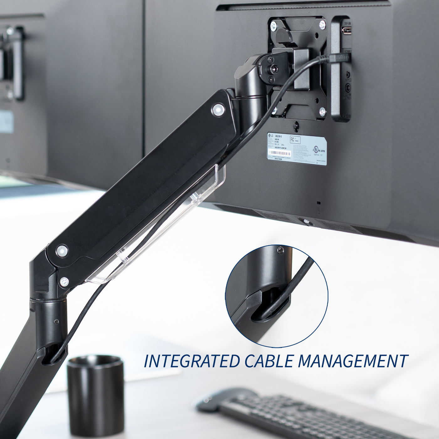 Adjustable pneumatic dual monitor desk mount for ultrawide monitors with integrated cable management.