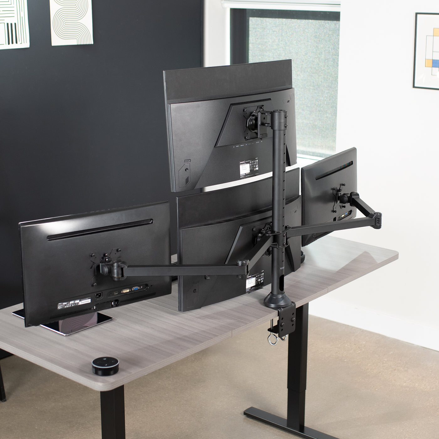 Quad monitor desk mount gives user multiple screens on one stand to multitask and have more viewing flexibility.