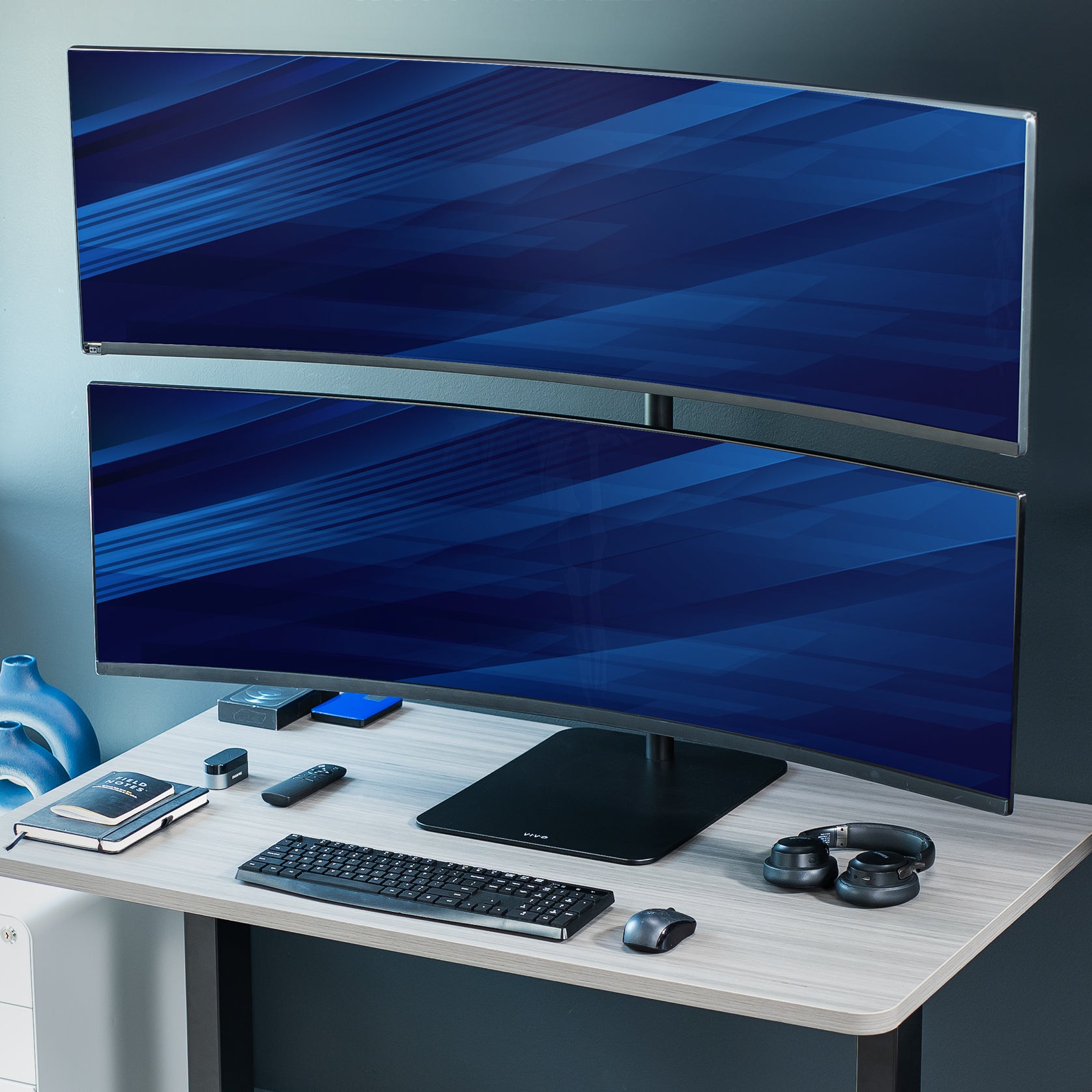 Dual Ultrawide Vertical Monitor Desk Stand elevates 2 large monitors in a vertically stacked array for comfortable viewing angles and efficient use of desk space. The freestanding base provides excellent support with no need to drill or clamp into your desktop.