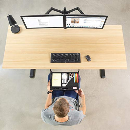 Man at office desk setup and utilizing under desk pencil drawer.