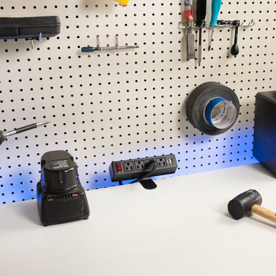 Clamp-on power strip in the workshop workspace charging electric battery-powered tools.