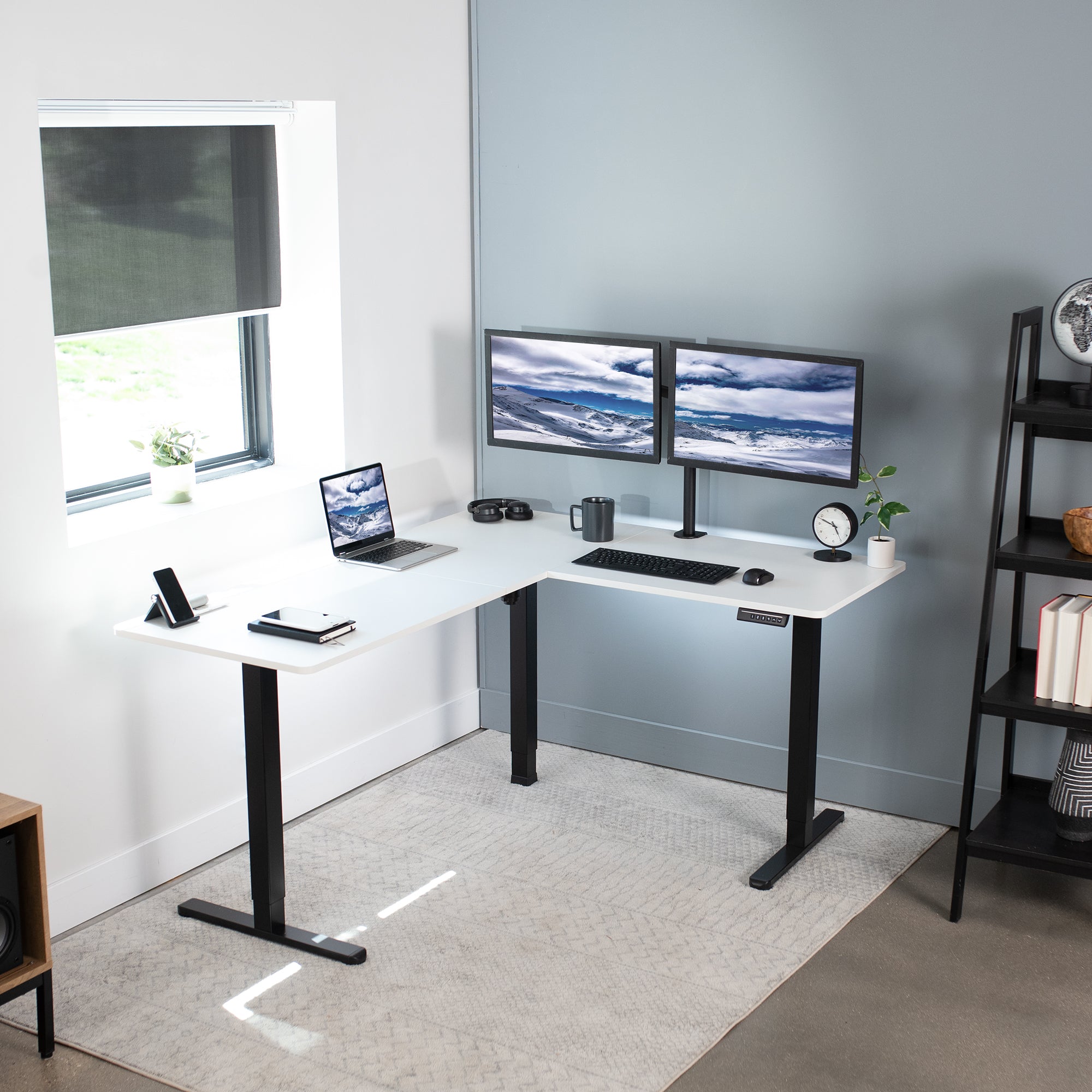 Electric heavy-duty corner desk workstation for modern office workspaces. 