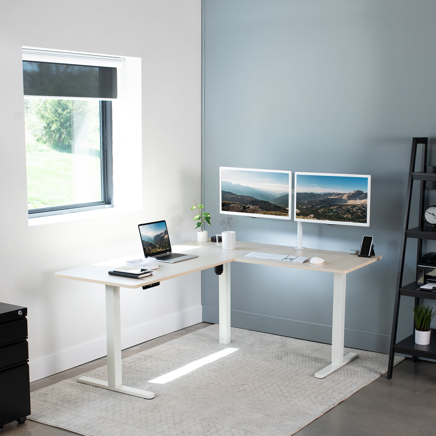 Electric heavy-duty corner desk workstation for modern office workspaces. 
