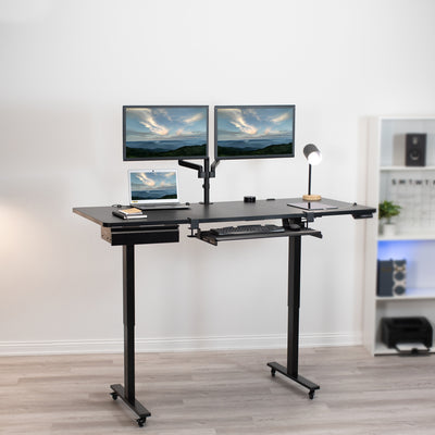 Dual monitor mount and laptop on a sit-to-stand workstation with keyboard tray and desk drawer.