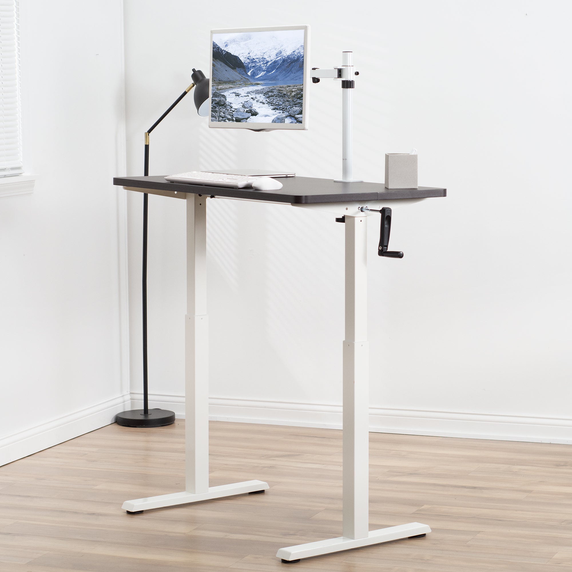 Manual hand crank height adjustable desk for active sit to stand workstation.