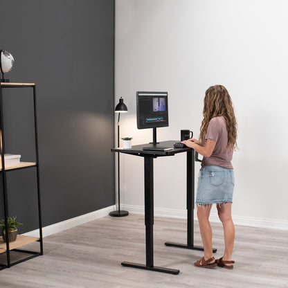 Woman working at an ergonomic height-adjustable desk.