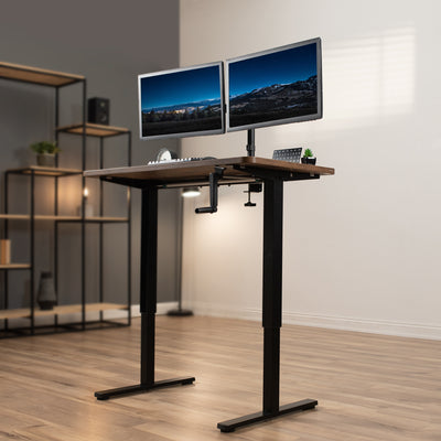 Compact steel desk frame with brown desktop and a dual monitor mount.