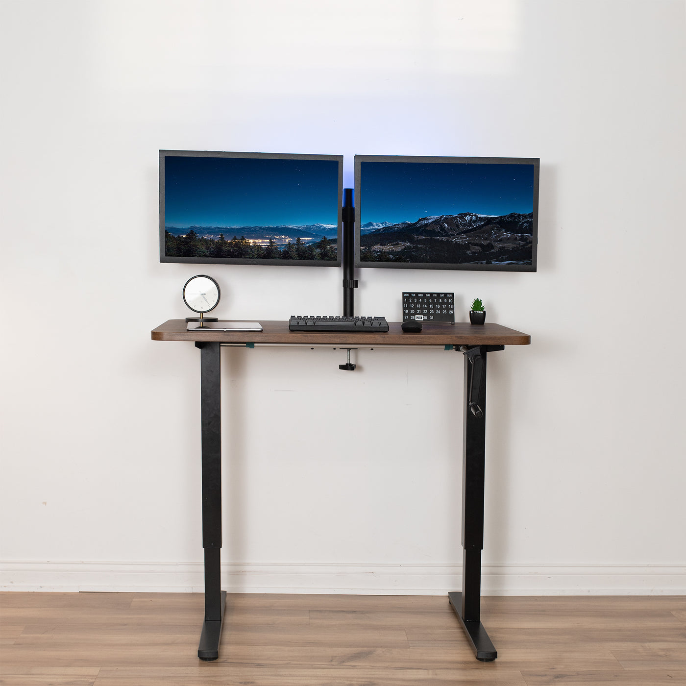 Height adjustable, non-electric sit-to-stand desk in minimalist office space.