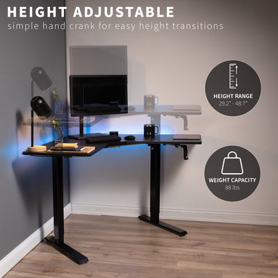 Heavy-duty manual hand crank adjustable height corner desk workstation with large height range.