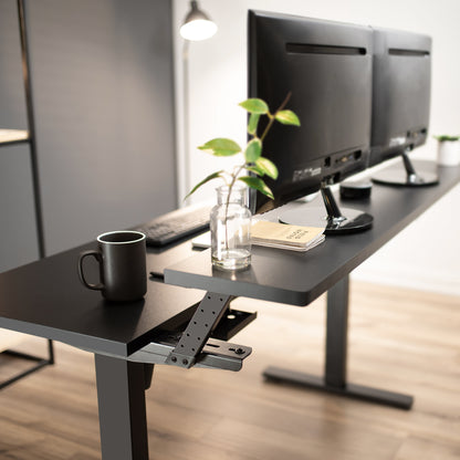 Heavy-duty adjustable sit or stand dual tier ergonomic office desk workstation.