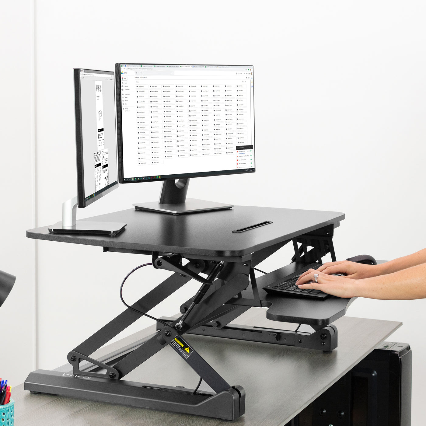 Heavy-duty height adjustable desk converter monitor riser with 2 tiers. 