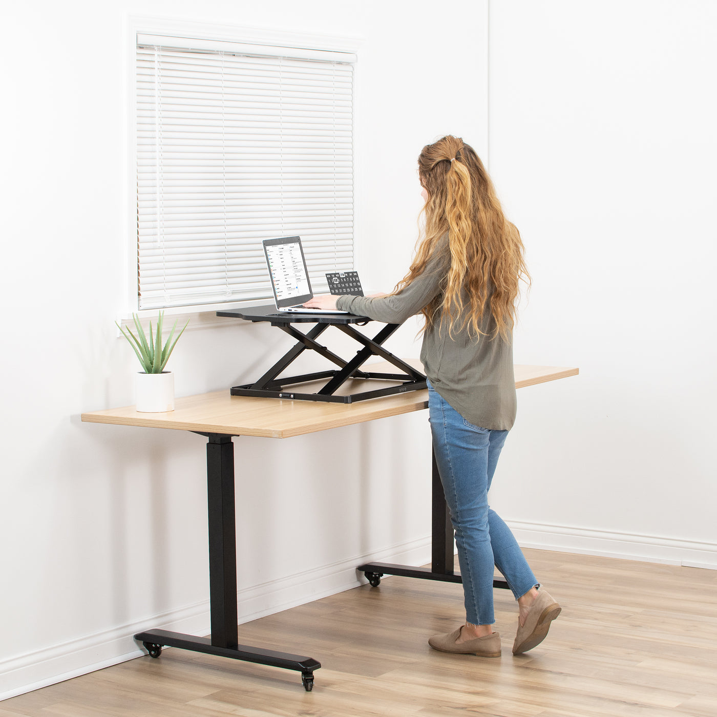 Heavy-duty height adjustable desk converter monitor riser.