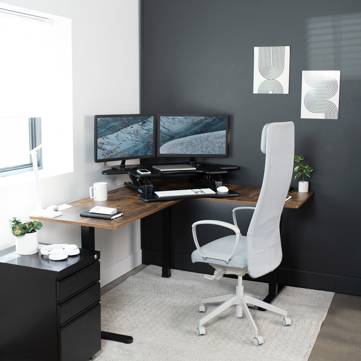 Heavy-duty height adjustable corner desk converter allowing for a spacious workspace.