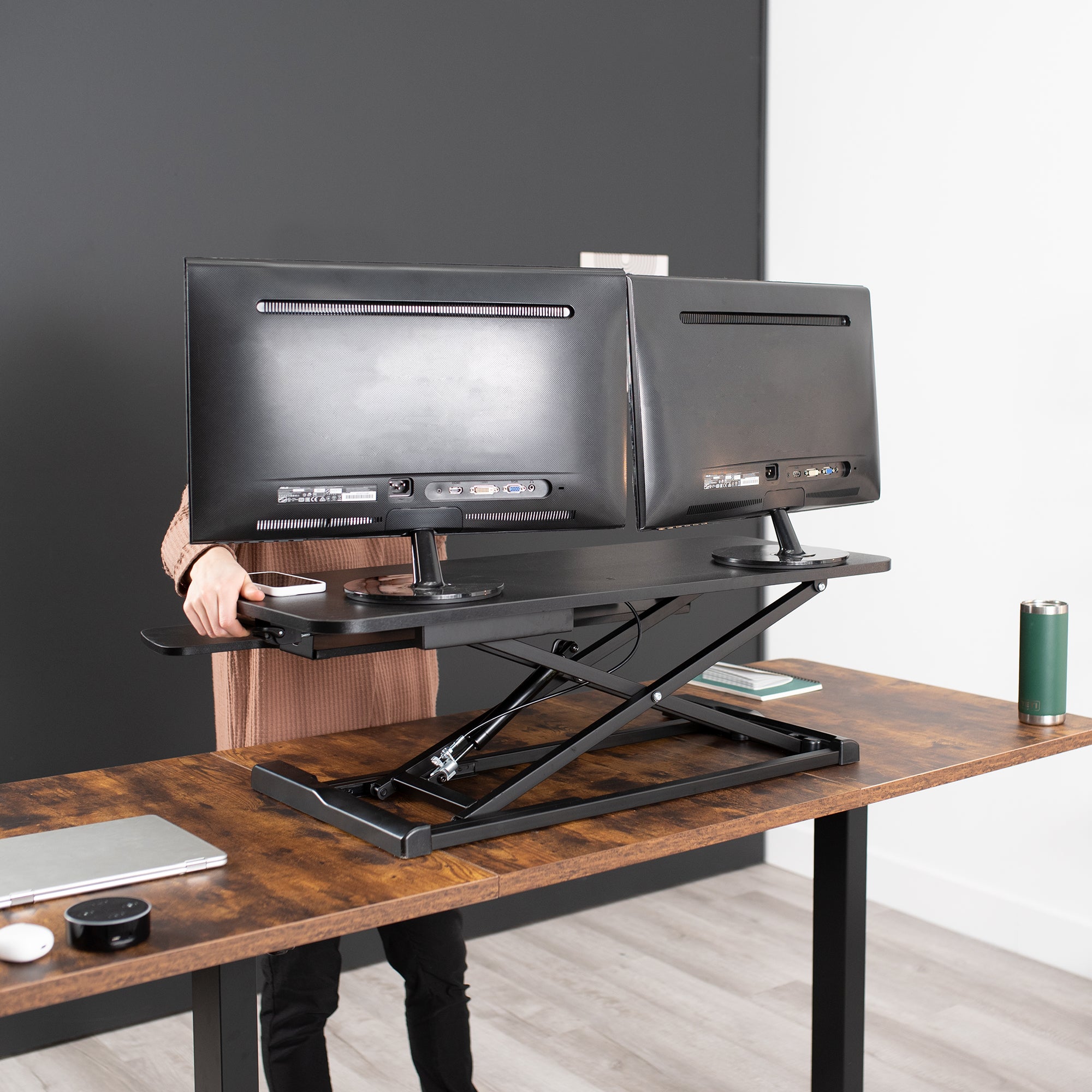 Heavy-duty height adjustable desk converter monitor riser with 2 tiers.