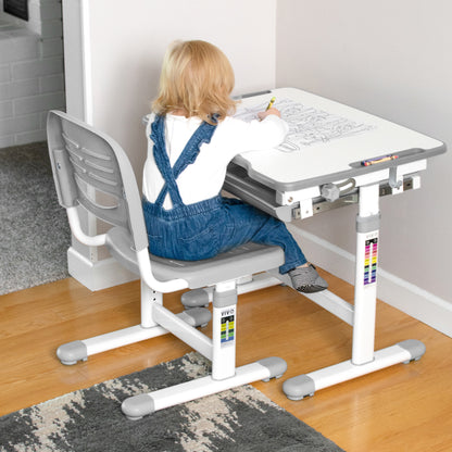 A toddler working from a children's desk.