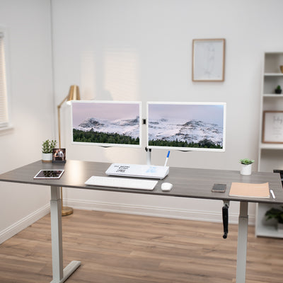 Dual monitor desk mount with whiteboard storage drawer and keyboard.