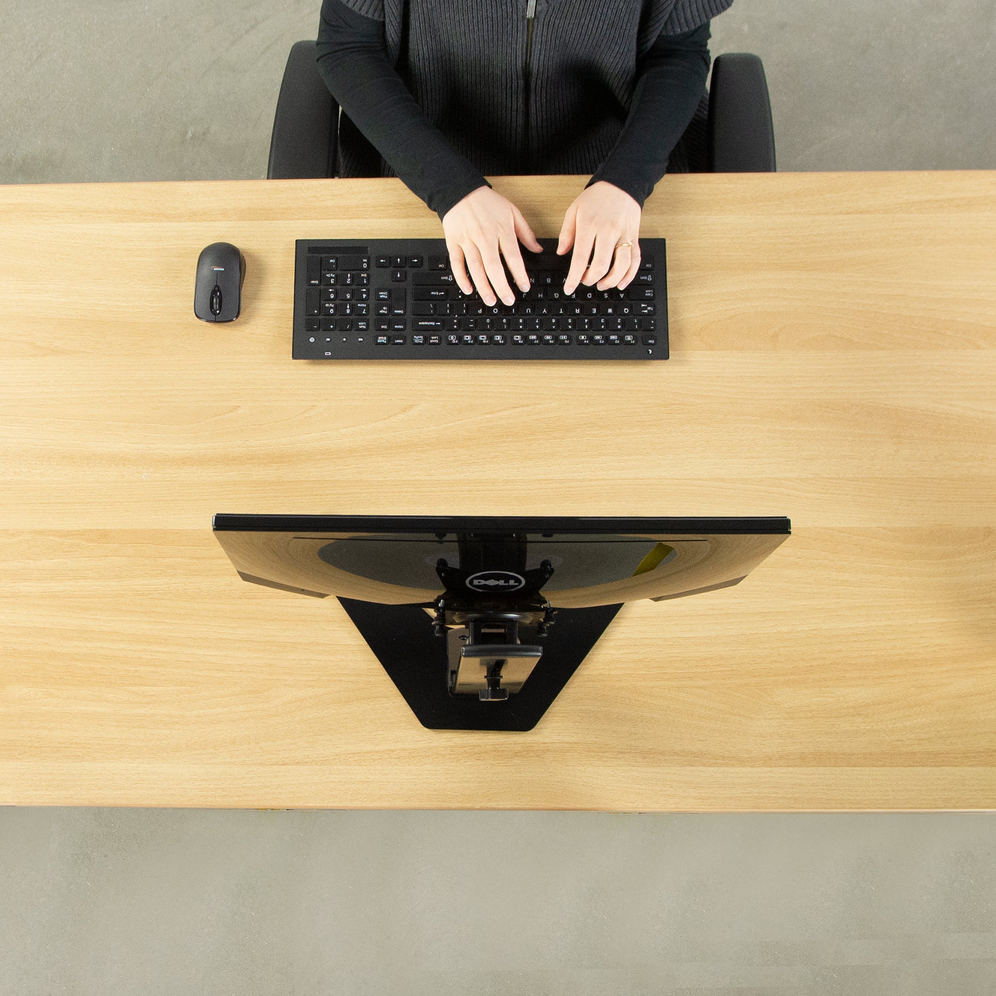 Ergonomic office desk set up to type and work from a mounted monitor.